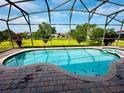 Beautiful screened-in pool area with lush green views, offering privacy and tranquility at 446 Summer Place Loop, Clermont, FL 34714