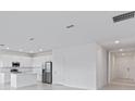 Open-concept living space connects kitchen and entryway, perfect for entertaining at 499 Silver Palm Dr, Haines City, FL 33844