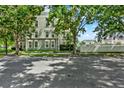A charming exterior view of a multi-story home with lush trees and landscaping at 501 Water St # 501, Celebration, FL 34747