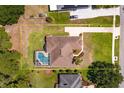 Full property aerial view showing the pool, lanai, driveway, surrounding landscaping and generous lot size at 513 N Pine Meadow Dr, Debary, FL 32713