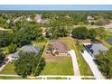 Expansive aerial shot highlighting the property's landscaped yard, mature trees, and neighborhood setting at 513 N Pine Meadow Dr, Debary, FL 32713