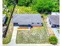 Aerial view of a well-maintained property with landscaped front yard and ample green space at 5513 Riordan Way, Orlando, FL 32808