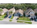 A bird's eye view of the home nestled among lush greenery in a quiet neighborhood at 637 Blenheim Loop, Winter Springs, FL 32708