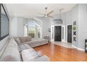Spacious living room featuring hardwood floors and large windows for ample natural light at 637 Blenheim Loop, Winter Springs, FL 32708