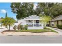 Charming home with a welcoming front porch, manicured landscaping, and classic curb appeal at 674 Douglas Ave, Winter Park, FL 32789