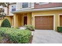 Charming townhome entrance featuring a one car garage and manicured landscaping at 707 Marotta Loop, Ocoee, FL 34761