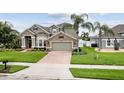 Charming two-story home with stone accents, a two-car garage, and a lush front lawn at 724 Duff Dr, Winter Garden, FL 34787
