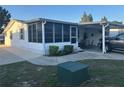 Well-maintained single-story home with a screened porch and covered parking at 816 Polo Park East Blvd, Davenport, FL 33897