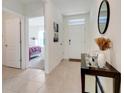 Neutral hallway with views to a bedroom and the front door entrance at 11284 Amber Ridge Dr, Zellwood, FL 32798