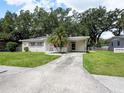 Charming single-story home with a well-maintained lawn and a palm tree in the front yard at 1244 Woodland Ave, Lakeland, FL 33801
