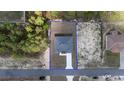 Aerial view of a property with a neatly paved driveway and well-maintained landscaping at 13420 Sw 77Th Ave, Ocala, FL 34473