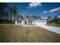 Well-maintained one-story home with a spacious driveway and a neatly landscaped front yard at 13420 Sw 77Th Ave, Ocala, FL 34473
