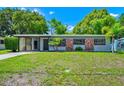 Inviting single-story home with well-maintained landscaping and brick accents at 1408 Watts Ave, Orlando, FL 32809