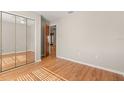 Bedroom with a mirrored closet door and a doorway to another room at 1415 Hensley Dr, Deland, FL 32724