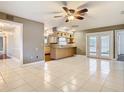 Spacious living room featuring tile flooring and an open layout with a view of the kitchen at 148 Tarrytown Trl, Longwood, FL 32750