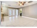 Bright, open living space with tile flooring and French doors leading to the outdoor area at 148 Tarrytown Trl, Longwood, FL 32750