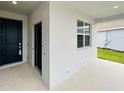 The front door, showing the door and the outdoor patio area of the home at 1590 Contentment Loop, Kissimmee, FL 34744