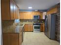 Bright kitchen features granite countertops, stainless appliances, and wood cabinetry at 1695 E Horatio Ave, Maitland, FL 32751