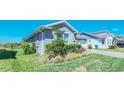 The home's exterior includes mature shrubs and landscaping at 18851 Rawson St, Orlando, FL 32827