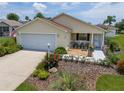 Beautiful single-story home with a well-kept lawn and colorful flower beds at 2167 Kerwood Loop, The Villages, FL 32162