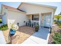 Welcoming front porch with a cozy seating area, decorative plants, and inviting entrance to the house at 2167 Kerwood Loop, The Villages, FL 32162