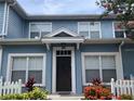 Charming two-story townhome with blue siding and a well-kept front yard at 2208 San Vittorino Cir # 104, Kissimmee, FL 34741
