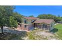 Aerial view of a two-story home with brick accents, a covered porch, and a spacious yard at 2500 Derby Dr, Kissimmee, FL 34744