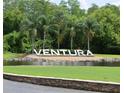 Community entrance with the 'Ventura' sign and palm trees surrounded by a pond at 3621 Atrium Dr # U-4, Orlando, FL 32822