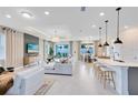 Open-concept living room and dining area with modern furnishings and plenty of natural light at 4007 Marbury Ct, Davenport, FL 33837