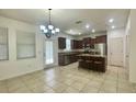 Spacious kitchen with stainless steel appliances, granite countertops, and a breakfast bar with seating at 4450 Capital Blvd, St Cloud, FL 34769