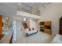Bright living room with high ceilings, tile floors, staircase, and elegant furnishings at 4527 Sandhurst Dr, Orlando, FL 32817