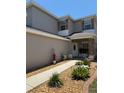Charming home with a welcoming front entrance, featuring manicured landscaping and stone accents at 5107 Ne 122Nd Blvd, Oxford, FL 34484