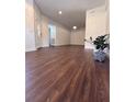 Spacious living room with hardwood floors, modern lighting, and a welcoming atmosphere at 5107 Ne 122Nd Blvd, Oxford, FL 34484