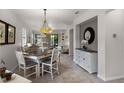 Open dining area with a rustic table and a stylish pendant light fixture at 532 Casanova Ct, Kissimmee, FL 34759