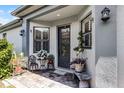 Inviting front porch with decorative seating, plants, and stylish exterior lighting at 532 Casanova Ct, Kissimmee, FL 34759