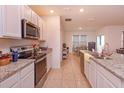 Bright kitchen with granite countertops, stainless steel appliances, and tile flooring at 5367 Douglas Fir Dr, St Cloud, FL 34771