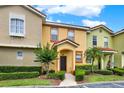 Cozy townhome with multiple units, manicured greenery, and a covered entrance at 540 Monroe Cir, Davenport, FL 33896