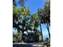 Quaint home nestled among mature trees, offering serene waterfront views at 629 Helen St, Mount Dora, FL 32757