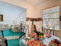 Dining area featuring a glass table with patterned linens and views into living room at 744 Wyman Ct # 744, Orlando, FL 32809