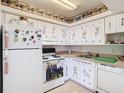 Charming kitchen with white appliances, ample cabinet space, and unique decorative touches at 744 Wyman Ct # 744, Orlando, FL 32809