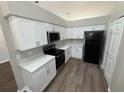 Efficient kitchen features white cabinets, updated appliances, and modern flooring for a sleek design at 7507 Sandstone Dr, Orlando, FL 32836