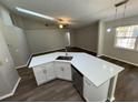 Bright kitchen featuring white cabinets, stainless steel appliances, and modern countertops under a vaulted ceiling at 7507 Sandstone Dr, Orlando, FL 32836