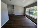 Spacious living room featuring modern floors, neutral paint, and a large window for natural light at 7507 Sandstone Dr, Orlando, FL 32836