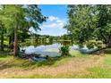 Scenic view of a tranquil pond reflecting the sky and lush greenery at 821 Shallow Brook Ave, Winter Springs, FL 32708