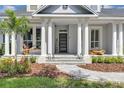 Inviting front porch with stone steps and beautiful landscaping at 8430 Woburn Ct, Windermere, FL 34786