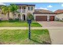 A beautiful home with a well-manicured lawn, landscaping, and an attached three-car garage at 8491 Pippen Dr, Orlando, FL 32836