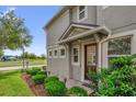 Inviting home exterior with a covered entryway and lush landscaping, showcasing its curb appeal at 8500 Iron Mountain Trl, Windermere, FL 34786