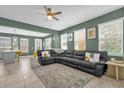 Spacious living room with large sectional couch, neutral rug, and plenty of natural light at 8500 Iron Mountain Trl, Windermere, FL 34786