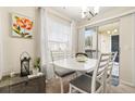 Charming dining area with white table set, bright natural light, and sliding glass door access at 1031 S Hiawassee Rd # 2517, Orlando, FL 32835