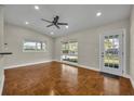Inviting living room with hardwood floors, vaulted ceilings, and access to the outdoors at 1120 Courtland St, Orlando, FL 32804